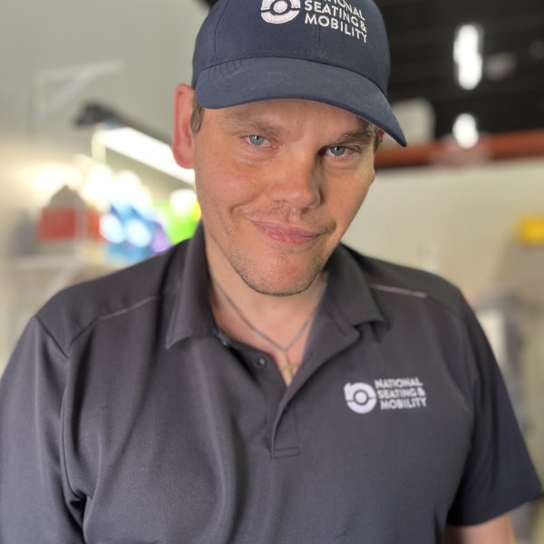 John smiling in his National Seating & Mobility swag on the job